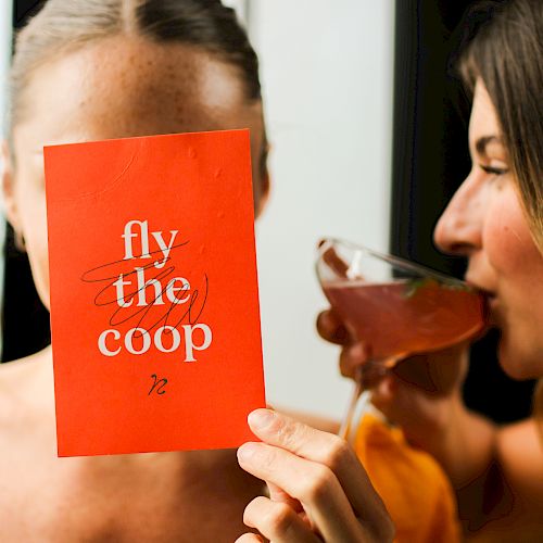A person holds a red card saying 
