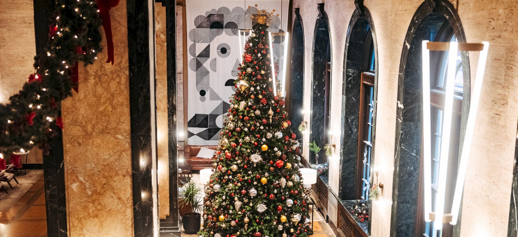 A decorated Christmas tree in a festive indoor setting.