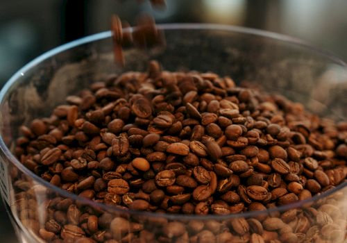 Coffee beans pouring into a container.
