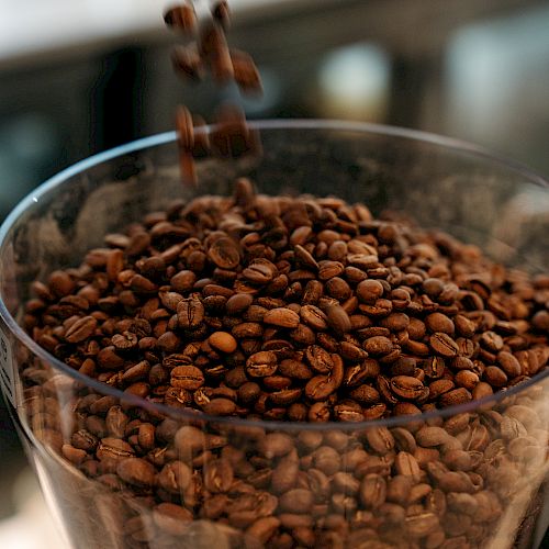 Coffee beans pouring into a container.